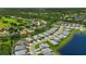 A captivating aerial view shows a residential area with homes surrounding a golf course and water features at 3621 Wild Blossom Pl, Parrish, FL 34219