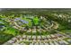 Gorgeous aerial view of a home nestled within a community with lush landscaping and scenic ponds at 3621 Wild Blossom Pl, Parrish, FL 34219
