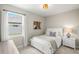Comfortable bedroom features neutral walls and carpet along with a white twin bed and desk at 3621 Wild Blossom Pl, Parrish, FL 34219