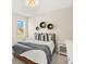 Neutral bedroom with a full size bed, side tables and a view to the home's backyard at 3621 Wild Blossom Pl, Parrish, FL 34219