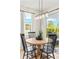 Dining area with natural light, modern light fixture, and access to outdoor space at 3621 Wild Blossom Pl, Parrish, FL 34219
