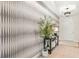 Beautiful foyer featuring stylish wallpaper, wood floors, modern light fixture, and accent furniture at 3621 Wild Blossom Pl, Parrish, FL 34219