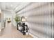 Elegant hallway with decorative console table, mirror, and stylish wallpaper creating a welcoming entrance at 3621 Wild Blossom Pl, Parrish, FL 34219
