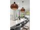 Close-up of a kitchen island with a quartz countertop and stylish pendant lighting at 3621 Wild Blossom Pl, Parrish, FL 34219