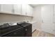 Well equipped laundry room featuring black washer and dryer units and a wash basin at 3621 Wild Blossom Pl, Parrish, FL 34219