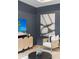 Cozy living room corner showcasing the accent wall, woven media cabinet, and stylish decor at 3621 Wild Blossom Pl, Parrish, FL 34219