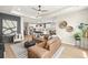 Open-concept living room with a view of the modern kitchen and dining area, perfect for entertaining at 3621 Wild Blossom Pl, Parrish, FL 34219