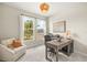 Home office featuring large windows, neutral walls and carpet and a modern wood desk at 3621 Wild Blossom Pl, Parrish, FL 34219