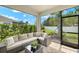Enclosed patio features comfortable wicker seating and views of the meticulously manicured backyard at 3621 Wild Blossom Pl, Parrish, FL 34219