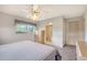 This bedroom contains neutral colored walls, carpet, and leads to the bathroom at 3641 Somerville Dr # 1506, Sarasota, FL 34232