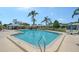 Large community pool surrounded by ample seating and lush landscaping at 3641 Somerville Dr # 1506, Sarasota, FL 34232