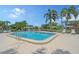 Community pool area with ample lounge chairs and lush landscaping at 3641 Somerville Dr # 1506, Sarasota, FL 34232