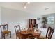 Cozy dining area with a wooden table set for four, enhanced by natural light and a view of the outdoors at 3641 Somerville Dr # 1506, Sarasota, FL 34232