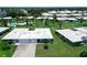 Exterior aerial shot of well-maintained home, manicured lawn, and lovely landscaping in a tranquil community setting at 3641 Somerville Dr # 1506, Sarasota, FL 34232