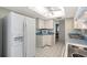 Well-lit kitchen with white appliances, cabinets, and neutral countertops at 3641 Somerville Dr # 1506, Sarasota, FL 34232