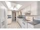 Bright kitchen with white cabinets and appliances, featuring ample counter space at 3641 Somerville Dr # 1506, Sarasota, FL 34232