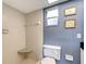 The shower has a marble bench and blue wallpaper on the adjacent wall at 3641 Somerville Dr # 1506, Sarasota, FL 34232