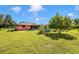 Landscaped backyard featuring lush greenery and a screened-in patio at 4145 W Price Blvd, North Port, FL 34286