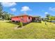 Manicured lawn with landscaping and a screened-in patio at 4145 W Price Blvd, North Port, FL 34286
