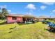 The backyard features lush green grass and a screened-in lanai at 4145 W Price Blvd, North Port, FL 34286