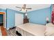 Bedroom featuring a ceiling fan, hardwood floors, a double door closet and blue walls at 4145 W Price Blvd, North Port, FL 34286