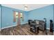 Bedroom with a wood-look floor, a window, a ceiling fan, a love seat and neutral curtains at 4145 W Price Blvd, North Port, FL 34286