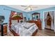 Cozy bedroom with hardwood floors, large bed, and natural light from window at 4145 W Price Blvd, North Port, FL 34286