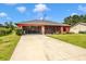 Single-Gathering home with a front lawn and a screened garage at 4145 W Price Blvd, North Port, FL 34286
