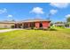 Single-Gathering home with a long driveway and a spacious front lawn at 4145 W Price Blvd, North Port, FL 34286