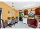 Well-lit kitchen featuring wood cabinetry, tile floors, and a view to outdoor patio at 4145 W Price Blvd, North Port, FL 34286