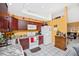 Well-appointed kitchen with wooden cabinets, white appliances, and tile flooring at 4145 W Price Blvd, North Port, FL 34286