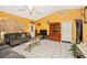 Inviting living room featuring tile floors, a ceiling fan, and a cozy seating arrangement at 4145 W Price Blvd, North Port, FL 34286