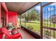 Relaxing screened-in porch with outdoor seating and a view of the front yard at 4145 W Price Blvd, North Port, FL 34286