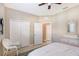 Bedroom with tiled flooring and walk-in closet and neutral colored walls at 4200 Reflections Pkwy, Sarasota, FL 34233