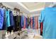 Well-organized walk-in closet with ample storage space and shelving for clothes and accessories at 4200 Reflections Pkwy, Sarasota, FL 34233