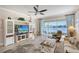 Comfortable living room boasts custom TV built-ins and a large window with water views at 4200 Reflections Pkwy, Sarasota, FL 34233