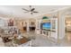 A spacious living room featuring a ceiling fan, neutral decor, and an entertainment center at 4200 Reflections Pkwy, Sarasota, FL 34233