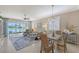Bright living area with ample seating, a dining area, and views of the serene lake at 4200 Reflections Pkwy, Sarasota, FL 34233