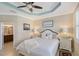 Comfortable main bedroom with white furnishings, soft lighting, and an ensuite bathroom at 4200 Reflections Pkwy, Sarasota, FL 34233