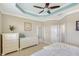 Bright and airy main bedroom with white furniture, a tray ceiling, and access to a walk-in closet and ensuite bathroom at 4200 Reflections Pkwy, Sarasota, FL 34233