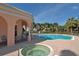 Resort-style pool and spa with a covered patio and palm tree landscaping in a well-maintained community at 4200 Reflections Pkwy, Sarasota, FL 34233