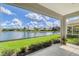 The screened patio with views of the lake and surrounding properties provides outdoor living at 4200 Reflections Pkwy, Sarasota, FL 34233