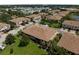 Aerial view of townhome community featuring manicured lawns, mature trees, and neatly arranged residential buildings at 4235 Overture Cir # 4235, Bradenton, FL 34209