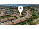 Aerial of a community with mature trees and a lake in the background at 4235 Overture Cir # 4235, Bradenton, FL 34209