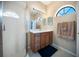 Bathroom featuring a vanity with a white countertop, wood cabinets, and a tiled shower at 4235 Overture Cir # 4235, Bradenton, FL 34209