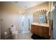 Bright bathroom featuring a glass-enclosed shower and a vanity with wood cabinets at 4235 Overture Cir # 4235, Bradenton, FL 34209