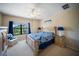 Bright bedroom featuring a well-dressed bed with blue accents and a view of the community's landscape at 4235 Overture Cir # 4235, Bradenton, FL 34209