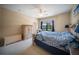 Spacious bedroom with a large bed, sitting chair and outside views from a window at 4235 Overture Cir # 4235, Bradenton, FL 34209