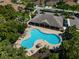 Aerial view of the community pool with ample lounge seating and a covered clubhouse at 4235 Overture Cir # 4235, Bradenton, FL 34209