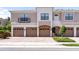 Attractive townhome featuring brick driveway, multiple garage doors, and neutral colored exterior at 4235 Overture Cir # 4235, Bradenton, FL 34209